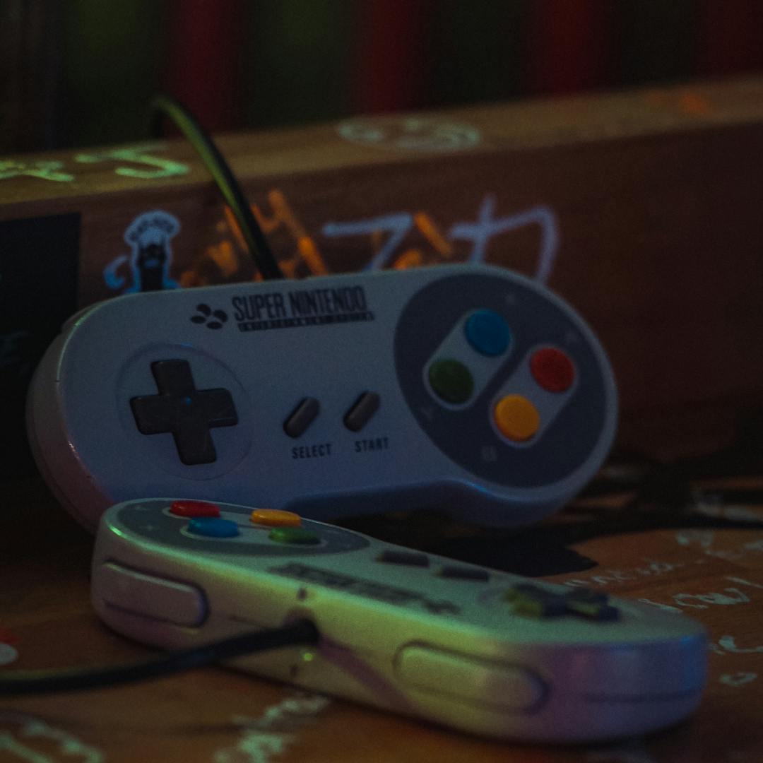 Super Nintendo controllers laid out on a dark surface