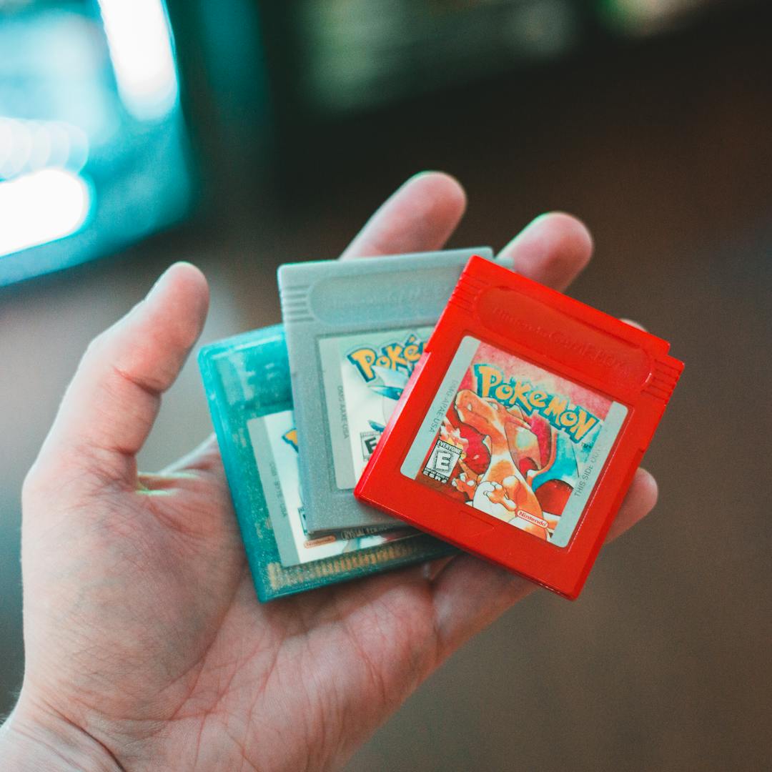 hand holding Pokemon game cartridges