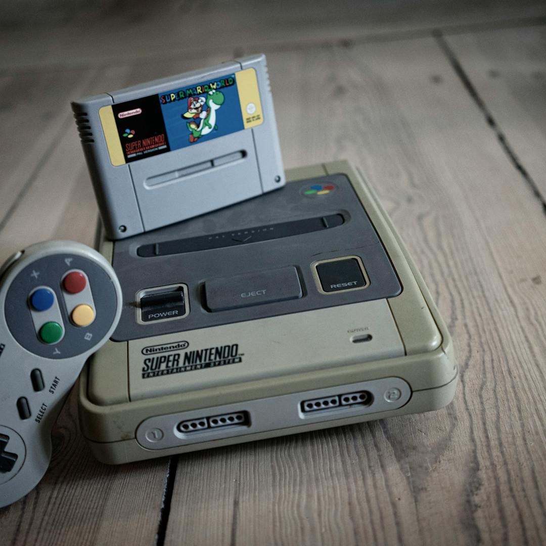 aged retro console with cartridge on wooden surface