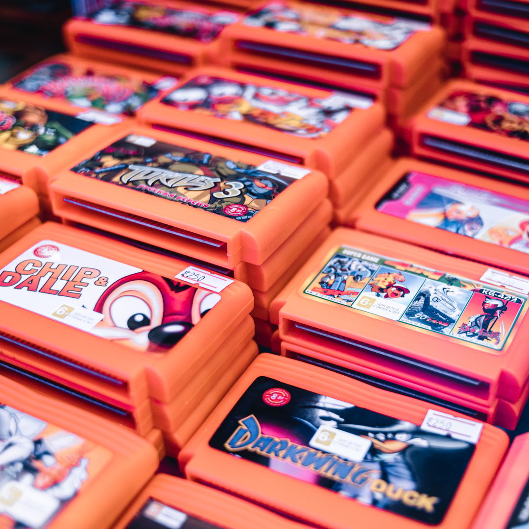 stacked retro game cartridges in coloured cases