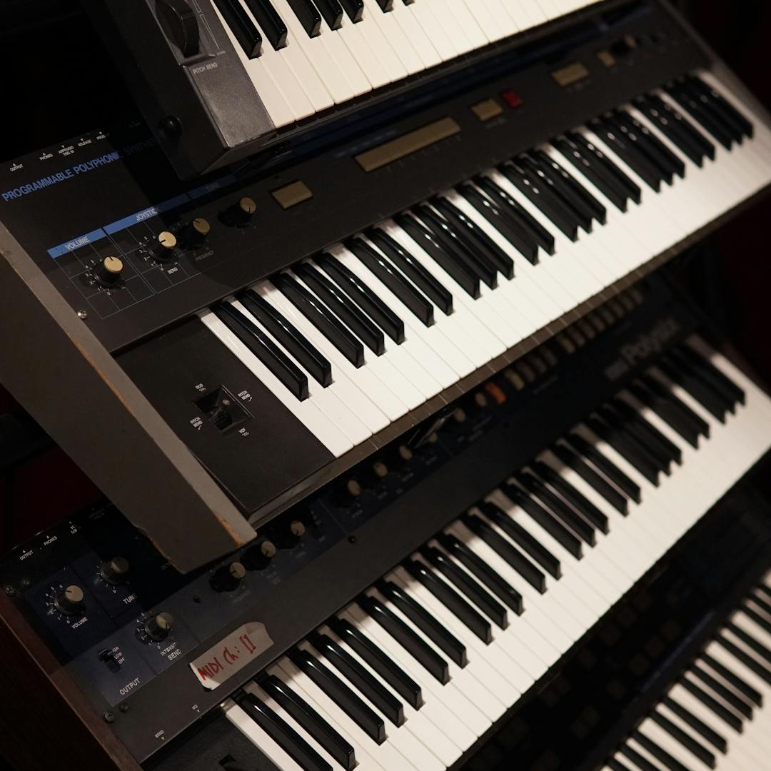 stacked vintage keyboards in music shop display
