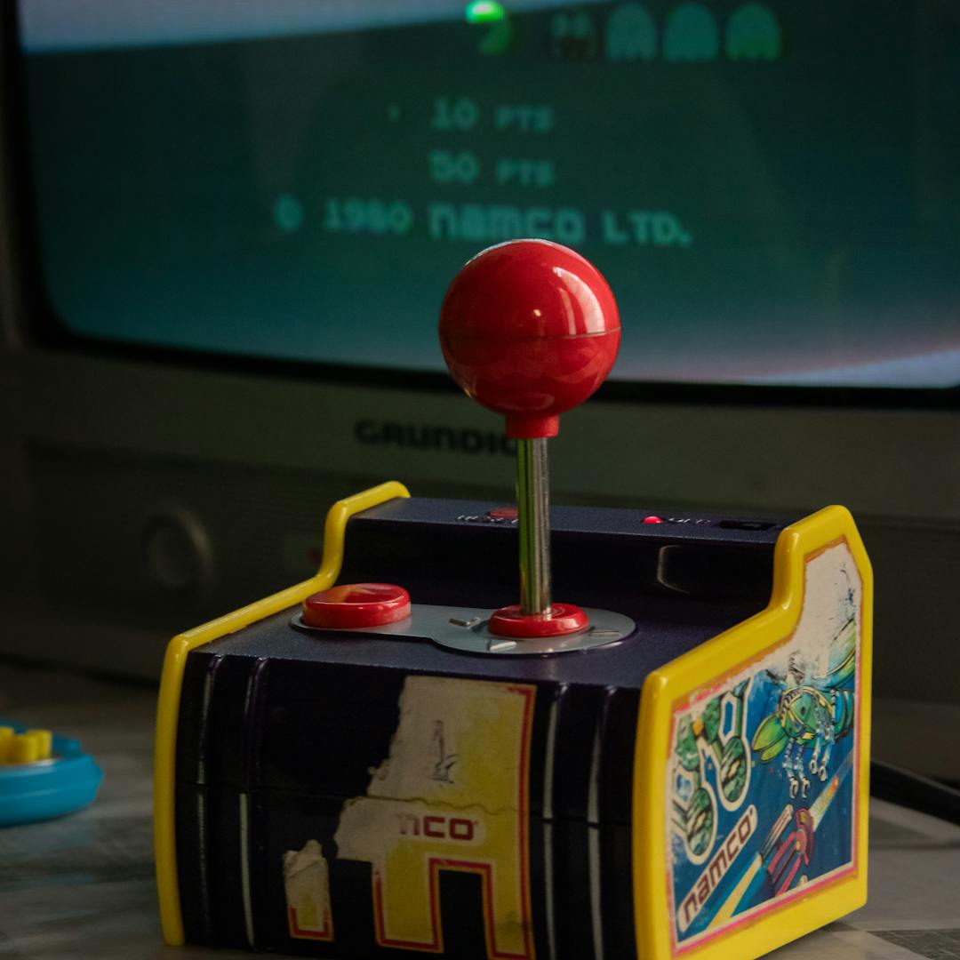 vintage joystick with arcade game display
