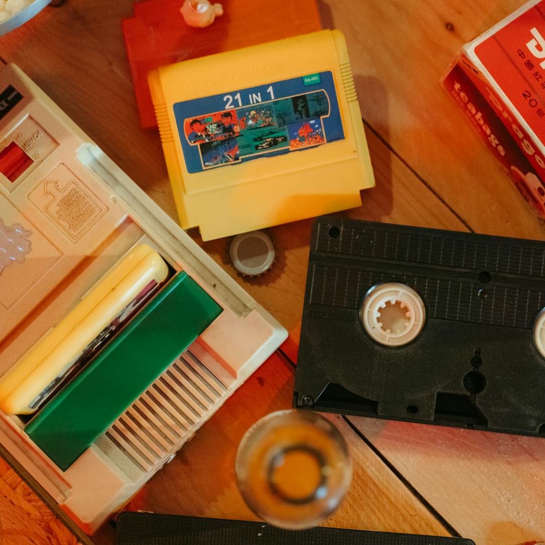 vintage gaming console with cartridges and VHS tape